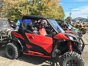 Vince Masse, spokesman with the Chatham-Kent ATV Club, is shown with his nine-year-old granddaughter, Kendall, during an event last year. (Handout)