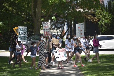 People march around Victoria Park as part of a Black Lives Matter protest in Woodstock on Sunday. (Kathleen Saylors/Woodstock-Sentinel-Review)