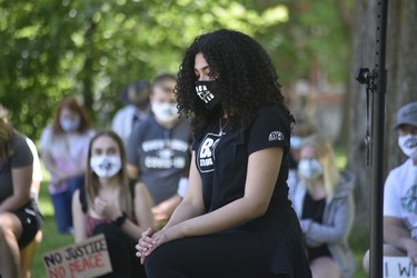 Hannah Hodder, one of the protest’s organizers, took a knee as the crowd observed silence in memory of George Floyd, the  Black man killed by police that sparked international protests. (Kathleen Saylors/Woodstock-Sentinel-Review)