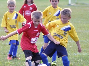 Logan Diegel (left) of the combined Mitchell U9 soccer team, the Rocky Mountain Chocolate Mocha Jeepsters, battles this Tavistock opponent during league play last summer on the Upper Thames field. Soccer in 2020 has been cancelled due to the COVID-19 pandemic. ANDY BADER/MITCHELL ADVOCATE