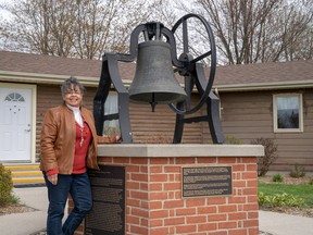 Shannon Prince, curator at the Buxton Museum and Historic Site, stands by a replica of the Liberty Bell. The original bell, donated in 1850, was rung to herald new refugees to the Elgin Settlement. Max Martin/Postmedia Network