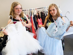 Sisters Faith, left, and Emma Vandermeer show two of the many prom dresses available at FreeHelpCK in Chatham, Ont., on Wednesday, June 10, 2020. Mark Malone