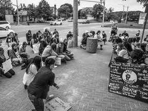 Residents take a knee on June 5 to protest the racisms that is ongoing in todays society. NFL Colin Kaepernick took a knee during the American anthem in 2016 to protest police brutality. 
Photo by Paul Grimand