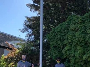 Dave Trumble, Sandy Blackwood and Fort Papalia raising the pride flag outside of the Kincardine library - all Kincardine Pride board members.