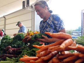 Maria Loewen of Loewen Greenhouses from Stratton, Ont., presides over her table of fresh vegetables at the Matiowski Farmer's Market last year. Food vendors will be the only ones during this 13-week farmer's market season.