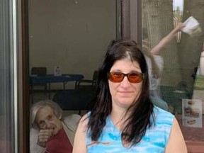 Valerie MacDonald poses for a picture with her grandmother, Nora Perron, during a window visit recently at Cassellholme Home for the Aged. The province announced residents in long-term care homes that do not have COVID-19 outbreaks will be allowed outdoor visits of one person per week starting June 18.