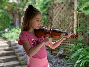 Leah Marquette performs for her parents and Stratford Strings Academy violin teacher Dini Westman in a socially-distant, solo, end-of-year, backyard recital on June 9 after three months of virtual lessons. (Submitted photo)