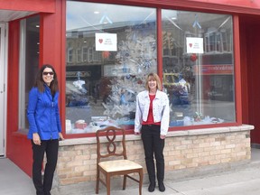 Huron Christmas Store owner Sandra Campbell stands in front of her store with Central Huron community improvement co-ordinator Angela Smith as they display a pre-decorated chair. Daniel Caudle