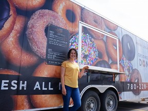 Kayanne Raber stands before the Crooked Creek Donut Truck at the Canadian Tire parking lot in Grande Prairie, Alta. on Saturday, June 13, 2020. Raber owns and operates the truck with her husband Nolan as a division of the store.