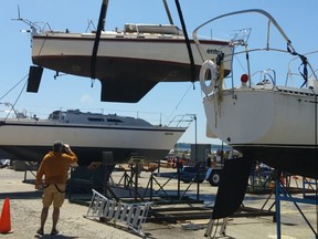 Excited but anxious sailboat owner Al Sawatzky manned a  guy rope as his 30-foot sailboat  ‘Entro’– his summer home  – was hoisted into Port Elgin Harbour during the annual Port Elgin Yacht Club lift-in June 6.
