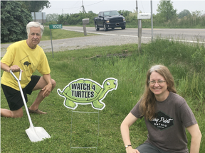 Long Point Biosphere directors John Everett and Cindy Presant with a "Watch 4 Turtles" sign. These signs are available for residents along the Causeway and throughout Long Point. (CONTRIBUTED)