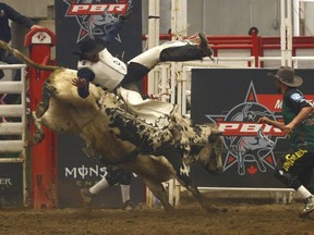 Rider Cole Young from Fairview, AB is bucked off Hold The Dark during Day 2 of the PBR Canada Monster Energy Tour's Calgary Classic. Saturday, March 23, 2019.