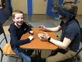 Big Brother Matt and Little Jack bond over a Blindfolded Puzzle Build activity, designed and facilitated by Big Brothers Big Sisters staff to develop communication skills. Supplied Photo)