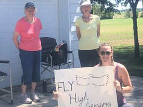 Janis Louwagie (foreground) displays a sign in front of grandmothers Christiane Louwagie (left) and Audrey Feltz, part of the team George and Harold's Warriors, during the Stratford Perth Hike for Hospice June 7. SUBMITTED