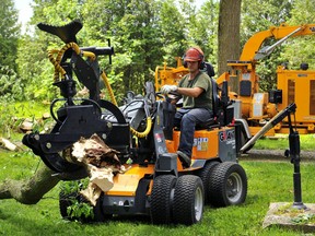 Wind damage from the violent storm on June 10 was especially severe in the countryside north of Waterford. Here, Dave Braun, owner of Timberjack Tree Service of Simcoe, cleans up a downed tree at a farm on Angling Road south of Boston. Monte Sonnenberg/Postmedia Network