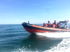 ]Using a rigid-hulled inflatable fast rescue craft the Canadian Coast Guard crew at Port Lambton is shown in action on the St. Clair River in 2018. Handout