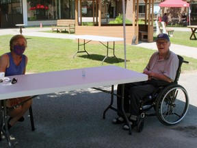 Sharon and Bob Hopper share a visit at Cassellholme Home for the Aged, Thursday. It was the first time since March they have been able to sit down and chat in person.
PJ Wilson/The Nugget