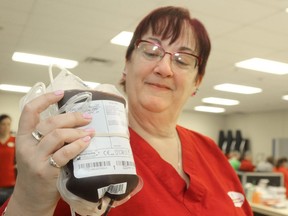 Phlebotomist Marianne McIlroy holds up a donated unit of blood at a Canadian Blood Services donor clinic in thie Postmedia file photo. National Blood Donor Week runs June 8 to 14 this year. A clinic is schedule for June 16 at Germania Club Hall in Pembroke. Mike Beitz/Postmedia Network File Photo