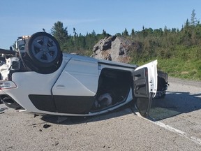 A vehicle rests upside down on Highway 69 south of Nelson Road on Tuesday after striking a rock cut and flipping. The driver, who has been charged with careless operation, suffered non-life-threatening injuries.