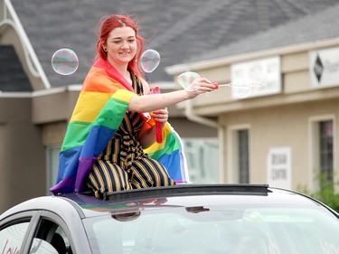 Participants could not toss objects to viewers like traditional parades due to the health concerns present in the province, but some, like the person here, blew bubbles to delight the public.