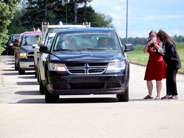 A long line of cars filled with students, family and friends turned out for Memorial Composite High School's drive-thru graduation ceremony Tuesday, June 16, 2020.