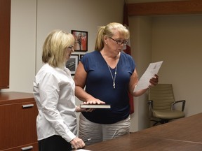 Leslie Farrell, right, takes her oath as she is sworn in to the Woodstock Police Service Board by Sharon Michalski, commissioner of oath. (Kathleen Saylors/Woodstock Sentinel-Review)