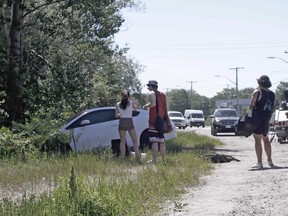 A white sedan is pulled out of a ditch on Lakeshore Drive, Friday, after being involved in a collision with a black SUV. Michael Lee/The Nugget