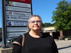 Shirley Roebuck, with the Ontario Health Coalition, stands outside the constituency office Sarnia-Lambton MPP Bob Bailey.