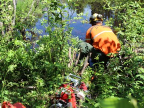 An Ontario FireRanger sets up a pump at a water source in a remote location in Ontario. supplied photo