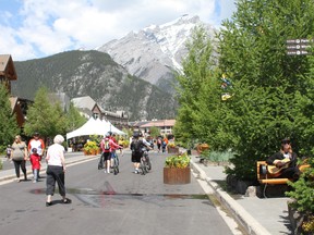 Tourists and residents enjoy the sunshine and atmosphere as they walk through the closed off area on Banff Avenue on June 20. Photo Marie Conboy.