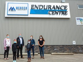 Left to Right: Crystal Gerbrandt, Amber Gottlob, Shawn Elliott, Celia Gottlob, Megan Heinen and Cameron Heinen stand afront the newly hung Mercer Peace River Endurance Centre sign, June 17, 2020. The new sign was hung June 12, 2020 to commemorate the sponsorship and subsequent renaming of the facility by Mercer Peace River.