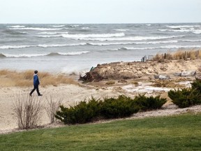 A resident walks along Ipperwash Beach on the shore of Lake Huron on Thursday December 11, 2014. (File  photo)