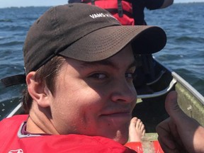 Brendan Hunter gives the thumbs up to Erik Olejnik as they help police and fire rescue two canoeists who capsized on Rondeau Bay on June 15. Handout