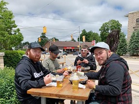 Lunch with some patrons trying new burgers, wraps, fries and poutines at Queen's Bush Pub.