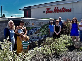 Local artist Aimee Movold and Devon Tim Hortons owner Brian Hicks unveiled a community art project on Tuesday, June 23. The mosaic mural is a piece crafted entirely of Tim Hortons gift cards, and was put together with the help of Movold and many helping hands around the community.