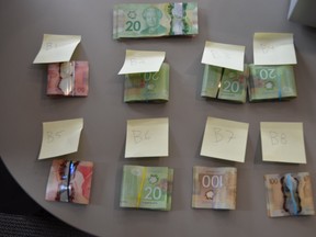 Cash seized when police executed a search warrant at a residence on Northland Road. (SUPPLIED PHOTO)