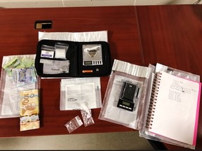 Norfolk OPP display some of the items seized following the execution of a search warrant at a home on Norfolk Street South in Simcoe this week. – OPP photo