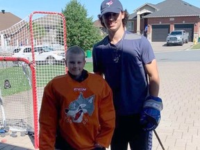 Sudbury Wolves winger Gio Biondi poses for a photo with Lukah Labrecque after a training session.