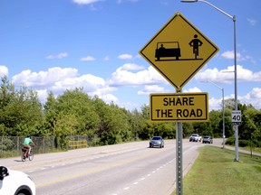 Share the Road signs and painted markings are seen along Memorial Drive, Monday. The city is testing the use of “advisory” bike lanes along the roadway and recently issued a tender for the construction of new standard bike lanes along Main Street West. Michael Lee/The Nugget