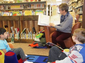 1,000 Books Before Kindergarten program launches at the Fairview Public Library on Jan. 27, 2018, as Library Manager Chris Burkholder reads an entertaining books to Zachary Chia (left), and Dawson Coady.