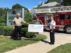 Petrolia and North Enniskillen Fire Department Chief Jay Arns, right, and Town of Petrolia Community Services Committee member Barbara Prescott, centre, present a cheque to the Charlotte Elanor Englehart Hospital Foundation’s Mark Braet, left, money raised during a May bottle drive.