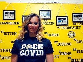 Lambton Elderly Outreach director of community services Laura Domingos models a “PUCK COVID” t-shirt in her “Sting Room.” The t-shirts are on sale for $25, with all funds going towards LEO, which has been helping Lambton County’s vulnerable population since the pandemic broke in March.