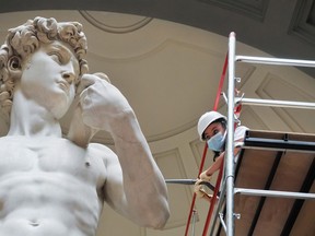 A restorer cleans Michelangelo's David statue while preparing for the reopening of the Galleria dell'Accademia which was closed for almost three months due to coronavirus on May 27 in Florence, Italy. The reopening was scheduled to take place on June 2nd.