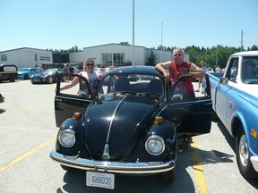 Saugeen Shores’ Robin Woods (right), allowed husband Dave Middleton, organizer of the first 'Cruising Grey Bruce' rally,  to drive her 1973 Beetle in the June 28 event that drew approximately 600 vehicles to the starting point at The Plex in Port Elgin.