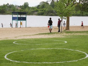 OTTAWA- May 29, 2020 --Physical distancing painted circles at Mooney's Bay's beach during COVID-19, May 29, 2020.