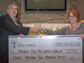 The Airdrie Community Foundation provides funding to local non-profits for worthwhile projects. In 2019, Chair Dale Rathgeber is seen presenting a cheque for $3,250 to Wendy Potter to support the 2020 Winter Games at the third annual Airdrie Community Foundation Gala. Photo by Kelsey Yates