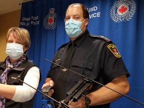 Victim Services managing director Anne Elliott displays a radio-transmitter on her wrist and OS Chief Craig Ambrose holds the tracking antenna which will be used to find people with cognative issues who are prone to roam and become lost. (Scott Dunn/The Sun Times/Postmedia Network)