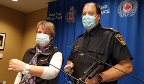 Victim Services managing director Anne Elliott displays a radio-transmitter on her wrist and OS Chief Craig Ambrose holds the tracking antenna which will be used to find people with cognative issues who are prone to roam and become lost. (Scott Dunn/The Sun Times/Postmedia Network)