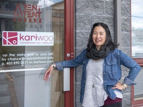 Jeweler Kari Woo wears some of her silver creations as she stands in front of her studio in the Elk Run Industrial Park in Canmore. photo by Pam Doyle/www.pamdoylephoto.com