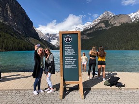 Tourists take photographs at Lake Louise on Friday, June 12. Park Canada are currently allowing 200 cars at any one time in the public parking area at Lake Louise. Lindsay McPherson, Park Canada Public relations and communications officer with Banff, Yoho and Kootenay national parks, said there is currently no shuttle bus service to Lake Louise in an effort to control social distancing. She said that these measures will remain in place for the foreseeable future, people are currently allowed to cycle in.
Photo Marie Conboy/ Postmedia.
